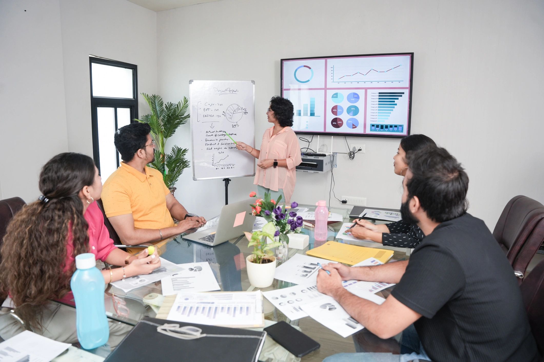 Team reviewing a strategy plan on a whiteboard